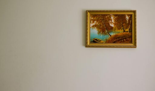 a single gold framed painting on the wall