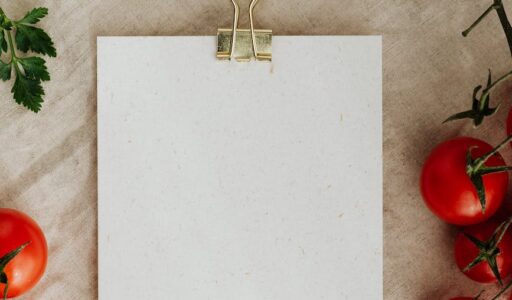 blank clipboard with fresh vegetables and herbs on table