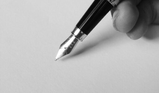 person holding fountain pen